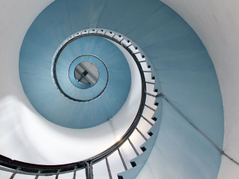 Looking up into the centre of a spiral staircase